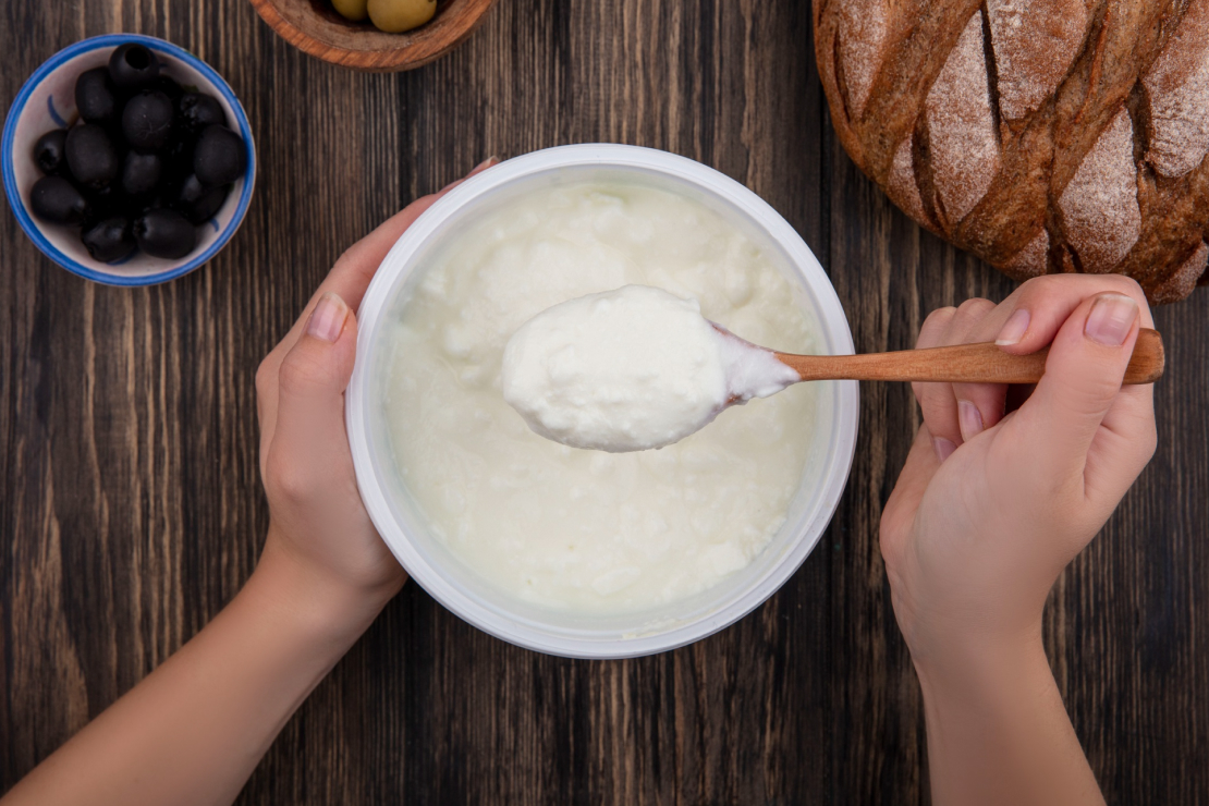 Bowl of Greek yogurt with berries and granola, symbolizing a healthy, high-protein snack.