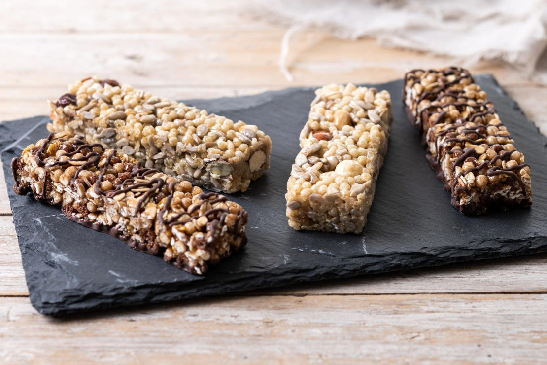 Assortment of protein bars with nutritional labels, symbolizing a choice between healthy and unhealthy options.